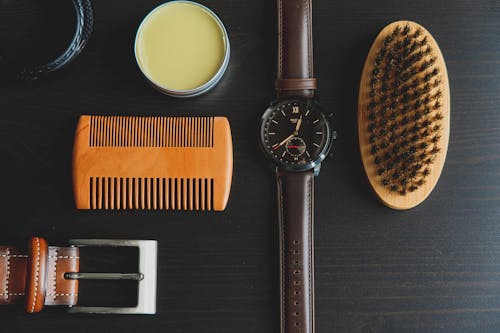 A pomade, comb, watch, belt and brush.