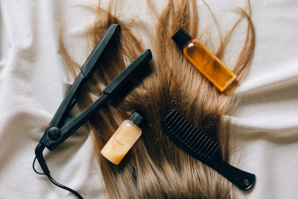 Hair products, including a comb, oil, conditioner, and a straightener.