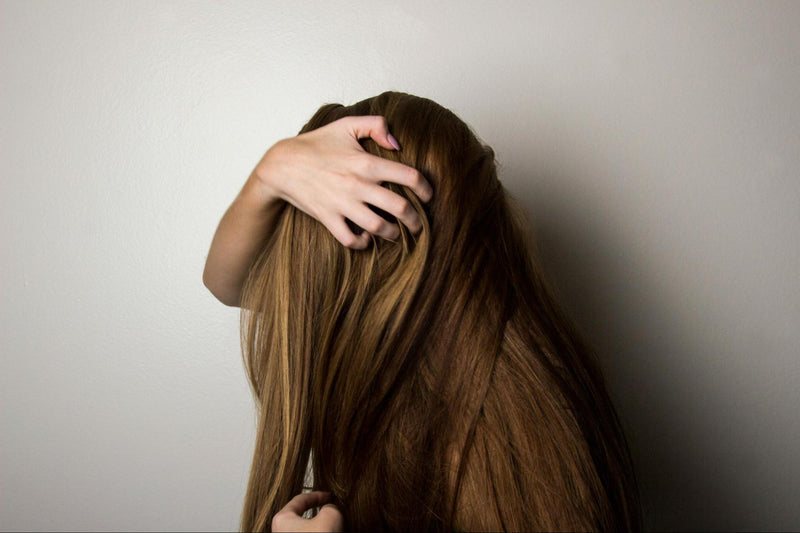 Woman running her hand through her hair