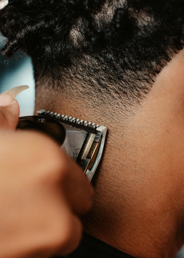 Person Trimming Back of another Person’s Neck with Clippers