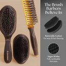 Black wave brush with oval head, bristle pins, and dark ergonomic handle—side view