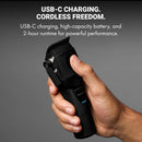 Matte black cordless hair clipper in hand, showing USB-C charging design