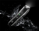 Black body trimmer with silver comb head, shown with water splash