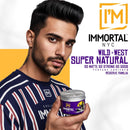 Man holding Immortal NYC Wild West Super Natural pomade tin with silver lid