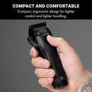 Hand holding a black compact clipper with ergonomic grip and front lever