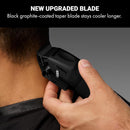 Hand holding matte black cordless hair clipper near hair for trimming