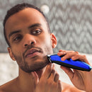 Blue and black beard trimmer with guard, shaving the chin and neck