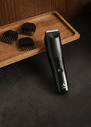 Black body trimmer with multiple detachable comb attachments on wooden tray