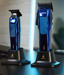 Two Andis Phenom navy clippers displayed upright in charging stands