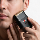 Gold foil head single-foil shaver to cheek, black body with green indicator light