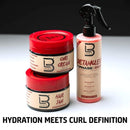Detangling spray bottle with black trigger and two red hair care jars.