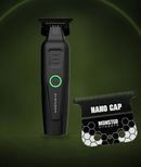 Cordless clipper with green-lit power button and blade guard accessory