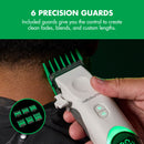White wireless hair clipper with green LED, handheld near skin with guard combs