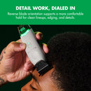 White wireless charging trimmer in hand with black blade and green LED battery screen