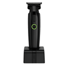 Black cordless hair trimmer with green accent dial and charging stand