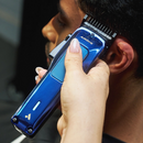 Andis Phenom navy clipper trimming hair around the ear