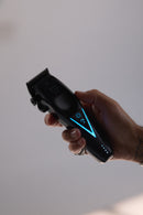 Wahl cordless hair clipper held up, blue indicator light and textured grip