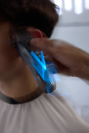 Wahl cordless hair clipper styling hair with bright blue vapor effect