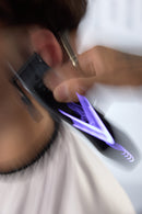 Wahl cordless hair clipper with purple accent glow, cutting blade head close-up
