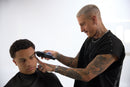 Barber using Wahl cordless hair clipper to style a client’s hair