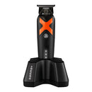 Cordless hair clipper with orange accents on a charging stand