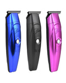 Three electric hair trimmers angled: blue, black, and pink with metal cutting heads.